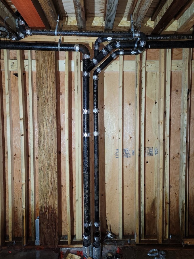 Plumbing rough-in running through timber wall studs