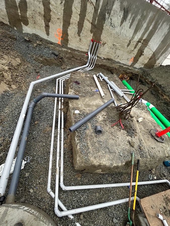 Underground drainage and supply rough-in before the slab is poured